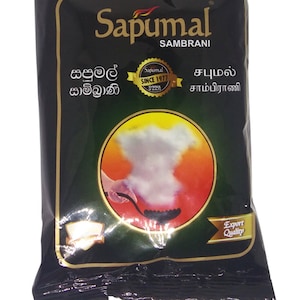 May include: A black and gold package of Sapumal Sambrani incense. The package features a white cloud of smoke rising from a burning stick of incense. The text on the package reads "Sapumal Sambrani" in English and Sinhala. The package also features a gold seal with the text "Sapumal Since 1977" and the words "Export Quality" in a gold ribbon.