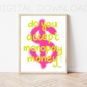 May include: A pink dollar sign with a yellow outline and the text "do you accept monopoly money?" in yellow letters.