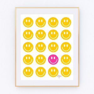 Puede incluir: Una impresi&oacute;n enmarcada con fondo blanco y una cuadr&iacute;cula de 16 caras sonrientes amarillas. Una cara sonriente en el centro de la cuadr&iacute;cula es rosa.
