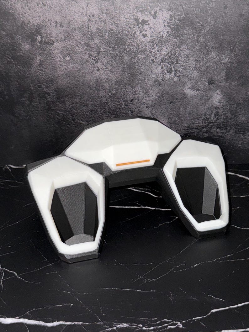 May include: A set of three ceramic mugs with a speckled, matte finish. The mugs are in cream, light grey, and dark grey. Each mug has a simple, minimalist design, ideal for coffee or tea.