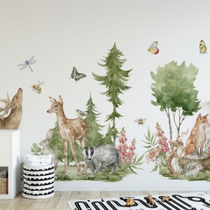 May include: A watercolor-style wall decal set featuring woodland animals, including a deer, fox, badger, and squirrel. The decals are surrounded by trees, flowers, butterflies, and bees, creating a whimsical forest scene.
