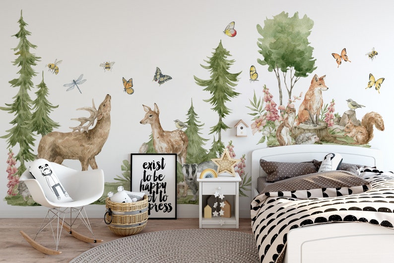 May include: A white wall with a woodland themed mural featuring a deer, a fox, a squirrel, and a badger. The mural also includes trees, flowers, butterflies, and bees. The mural is in a child's bedroom with a white rocking chair, a white nightstand, and a bed with a black and white patterned duvet cover. The text "exist to be happy it to press" is on a black framed print.