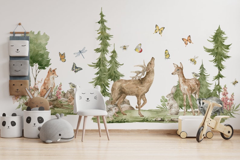 May include: A watercolor-style wall decal featuring a woodland scene with a deer, a fawn, a fox, a badger, butterflies, and dragonflies. The decal is perfect for a nursery or child's room.