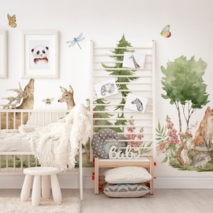 May include: A nursery room decorated with woodland animal wall decals. The decals feature a deer, a fox, a squirrel, a bird, butterflies, and trees. The room also has a white crib, a white stool, and a wooden shelf with the word "Baby" on it.
