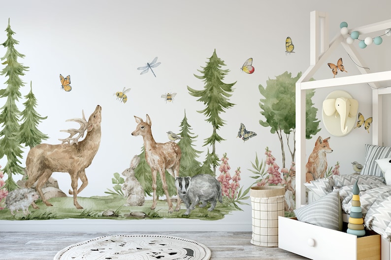 May include: A white wall with a woodland-themed mural featuring a deer, a fawn, a badger, a fox, butterflies, bees, and birds. The mural is surrounded by green trees and flowers.