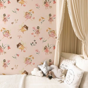 May include: A white canopy bed with a pink and green fairy wallpaper. The bed is decorated with white and gold pillows, a silver star pillow, and a stuffed bunny. The pillows have text that reads "You are so loved" and "Dream big little one".
