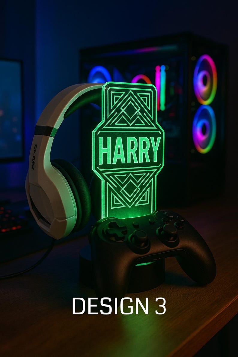 May include: A personalized green LED gaming lamp with the name "HARRY" displayed. The lamp is next to a black game controller and white headphones. The words "DESIGN 3" are at the bottom.