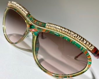 Vintage Christian Lacroix Sunglasses, green red frame, gold detailing, flower design pattern, name brand logo emblem on side, rare shades