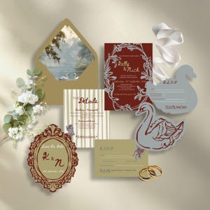 May include: Wedding invitation suite featuring a gold envelope with a swan scene, a burgundy invitation with floral accents, and swan-shaped RSVP cards. Includes gold rings and floral details, perfect for a romantic wedding theme.
