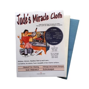 May include: Jude's Miracle Cloth package featuring a vintage kitchen scene. The pack contains two cloths, one cream and one blue, designed for streak-free cleaning of windows, mirrors, and stainless steel surfaces.