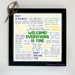 Puede incluir: Una impresión enmarcada con un esquema de color verde, amarillo y azul. La impresión presenta una colección de texto en una fuente pixelada, incluyendo las frases "Not a Robot", "Welcome! Everything is Fine", y "That Broke Me".