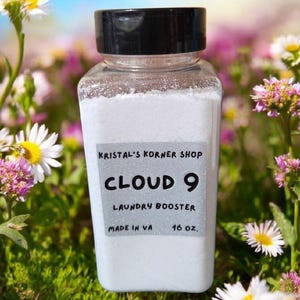 May include: A white plastic bottle with a black lid filled with white powder. The bottle has a label that says "Kristal's Korner Shop Cloud 9 Laundry Booster Made in VA 16 oz."