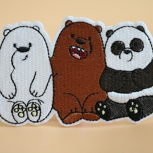 May include: Three embroidered patches featuring the characters from the cartoon "We Bare Bears". The patches are white, brown, and black and feature the characters Ice Bear, Grizzly, and Panda, respectively.