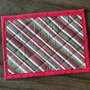 May include: A rustic wooden sign with the text "Welcome to our home" in white lettering. The sign features a distressed finish and a simple, inviting design, perfect for front door decor.