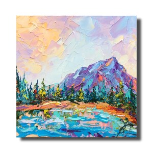 May include: A colourful abstract painting depicting a mountainous landscape with a lake in the foreground. The sky is a blend of pink, orange, and purple, while the mountain is a deep purple with touches of blue and green. The lake is a vibrant blue with streaks of pink and purple.