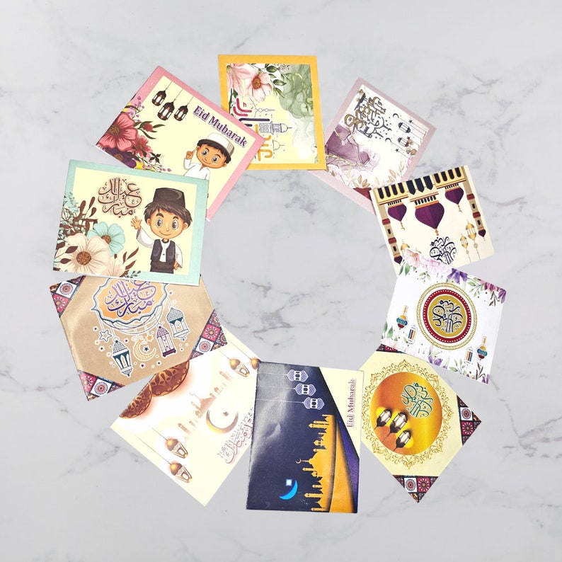 May include: A set of ten colorful greeting cards with Islamic calligraphy and illustrations. The cards feature a variety of designs, including lanterns, mosques, and stars. The cards are perfect for celebrating Eid al-Fitr or Eid al-Adha.