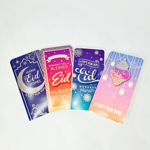 May include: Four colorful Eid Mubarak gift envelopes with gold accents and decorative patterns. The envelopes feature the text "A Gift for You" and "Eid Mubarak".