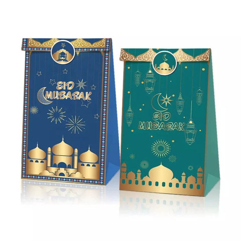 May include: Two gift bags with gold accents and a blue and green design. The bags feature the text "Eid Mubarak" and traditional Islamic imagery, including a mosque, crescent moon, and stars.