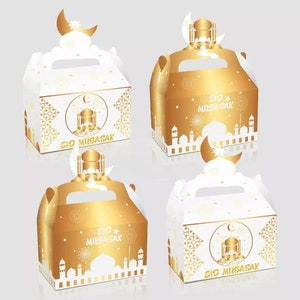 May include: Four gold and white favor boxes with a handle. The boxes have a mosque design and the text "Eid Mubarak" on them. The boxes are perfect for holding small gifts or treats.