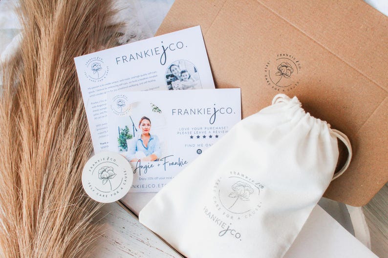 May include: Overhead shot of Frankie J Co. packaging, including a white drawstring bag, a round sticker, and a kraft paper envelope. The packaging features a floral logo and the text "Frankie J Co."