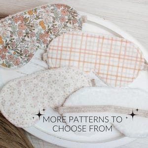 May include: Four different eye masks with various patterns. The eye masks are made of soft fabric and are designed to block out light. The patterns include floral, plaid, polka dot, and solid white. The text "MORE PATTERNS TO CHOOSE FROM" is printed on the bottom of the image.