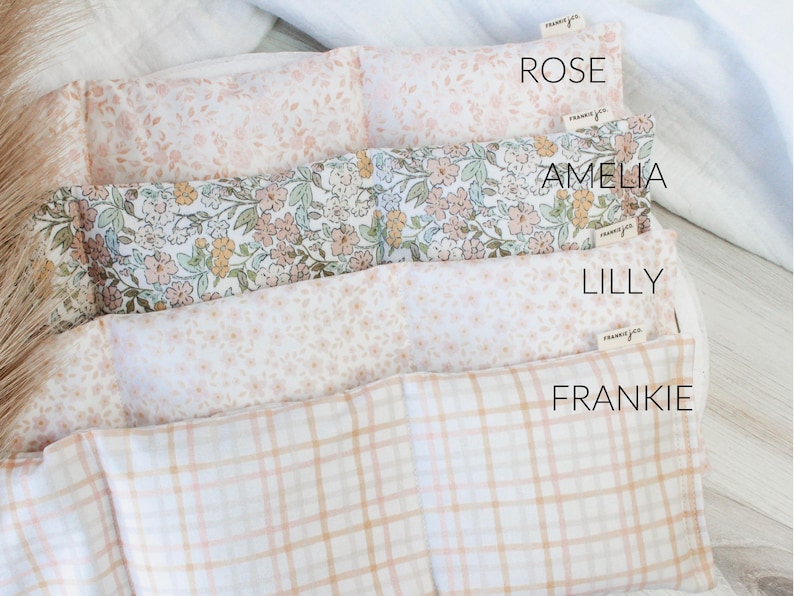 May include: Four rectangular fabric items with floral and plaid patterns. The top item is labeled "ROSE" and has a pink floral design. The second item, labeled "AMELIA", has a floral pattern with green, pink, and yellow flowers. The third item, labeled "LILLY", has a small floral pattern. The bottom item, labeled "FRANKIE", has a plaid pattern.