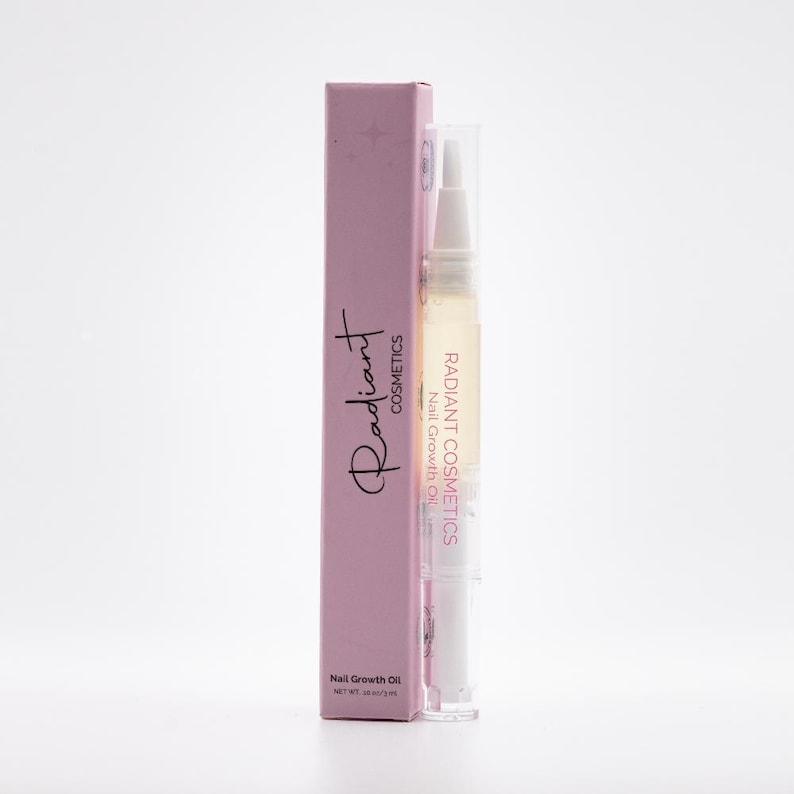 May include: A pink box and a clear nail growth oil pen. The box has the word "Radiant" in script and the words "Cosmetics" and "Nail Growth Oil". The pen has the words "Radiant Cosmetics Nail Growth Oil".