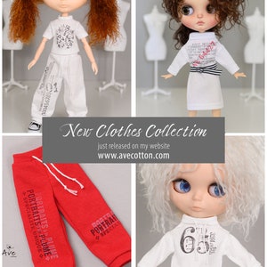 May include: A collection of doll clothes featuring a white t-shirt with black numbers, white pants with black numbers, a white dress with black stripes and red numbers, red sweatpants with black text, and a white sweatshirt with black numbers and text.