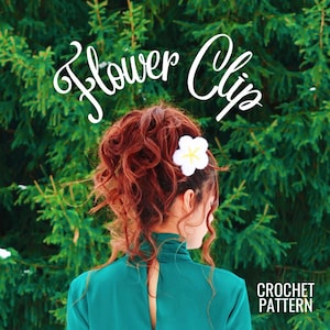 May include: A white crochet flower clip with a yellow center, worn in a woman's red curly hair. The text "Flower Clip" is written in white cursive above the woman's head. The text "CROCHET PATTERN" is written in white below the woman's hair.