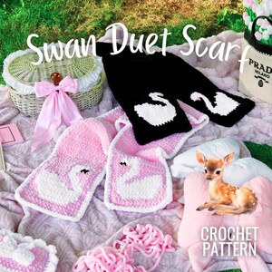 May include: A black scarf featuring white swan motifs and a pink scarf featuring white swan motifs, both with crochet textures. The text "Swan Duet Scarf" and "CROCHET PATTERN" is visible on the image, alongside a woven basket with a pink bow.