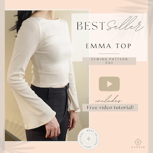 May include: Cream-colored long-sleeve top with a boat neck and flared sleeves. The image includes the text "BEST Seller" and "EMMA TOP", along with "SEWING PATTERN PDF" and "Free video tutorial!"