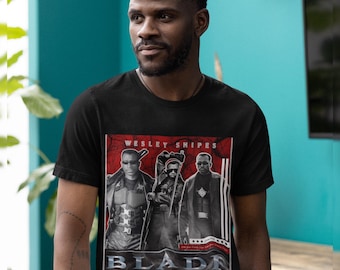 May include: Black t-shirt featuring a graphic of Wesley Snipes from the movie Blade. The graphic includes images of the actor and the word "BLADE" in a bold font. The shirt is a classic crew neck style.