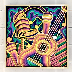May include: A colourful, layered paper art piece depicting a guitar, microphone, and drums. The artwork is framed in gold and features a variety of vibrant colours, including purple, blue, green, yellow, and orange.