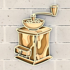 Puede incluir: Un molinillo de café de madera con una manivela. El molinillo está hecho de madera marrón claro con un patrón de veta de madera marrón más oscuro. El molinillo tiene un tolva redonda en la parte superior y un cajón en la parte inferior.