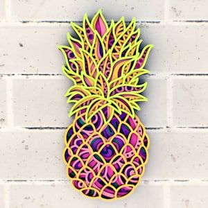 May include: A colorful, intricate pineapple design with yellow, pink, and purple details. The pineapple is outlined in yellow and has a detailed, patterned design.