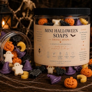 May include: A clear plastic jar filled with mini Halloween soaps in shapes of orange pumpkins, white ghosts, purple witch hats, black bats, and yellow moons. The label reads MINI HALLOWEEN SOAPS, TRAVEL SOAPS, and lists ingredients and icons.