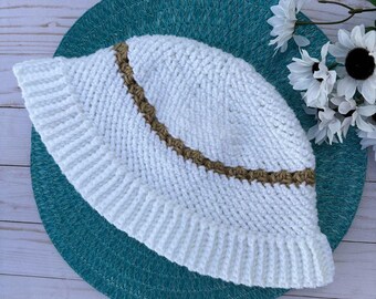 May include: White crochet bucket hat with a brown crocheted trim around the brim.