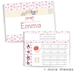 May include: A spiral-bound alphabet book with a pink bow pattern. The cover features the name "Emma" in a pink font. Inside, pages display letter tracing exercises with illustrations of an apple and baseball.