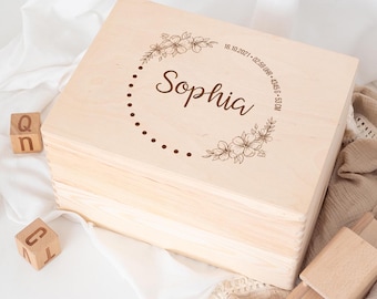 Può includere: Una scatola portaoggetti in legno chiaro con un design floreale e il nome "Sophia" inciso sul coperchio. La scatola include anche la data "18.10.2021", l'ora "02:50 Uhr", il peso "3455 g" e la lunghezza "53 cm".