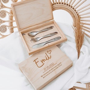 May include: Wooden box with a set of engraved silverware and a personalized message for Emil, dated 27.05.2022. The message reads "We wish you a good appetite! Your Aunt Chrissi and your Uncle Thomas."
