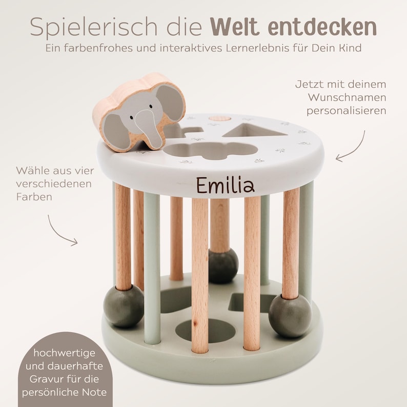 May include: A wooden toy with a light green base and wooden dowels. The toy has a removable elephant shape and a removable geometric shape. The base of the toy has the name "Emilia" engraved on it.