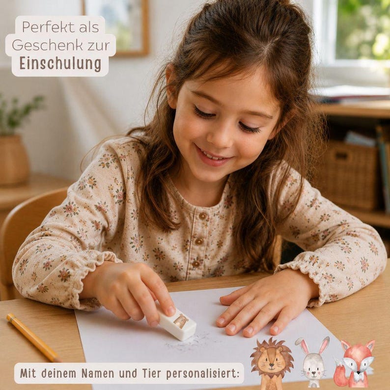 May include: A white rectangular eraser featuring a small animal illustration, positioned on a sheet of white paper. The eraser is personalised with a name and an animal graphic, including a lion, a rabbit, and a fox shown at the bottom.