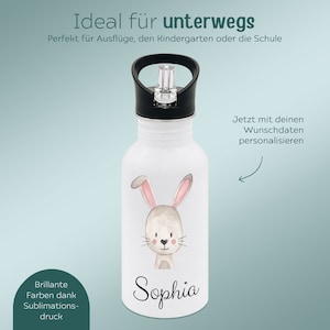 May include: A white water bottle featuring a black lid with a carry loop and a clear straw. The front of the bottle displays a watercolor-style illustration of a light brown bunny with pink ears and the name Sophia written in black script text.