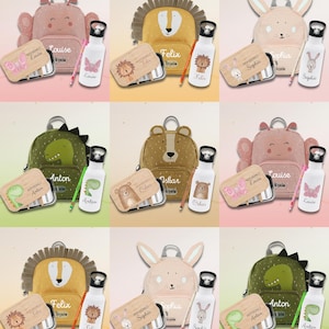 Puede incluir: Una colección de mochilas, fiambreras, botellas de agua y lápices para niños. Las mochilas presentan diseños de animales, como un león, un oso, un dinosaurio y un conejito. Las fiambreras y botellas de agua están coordinadas.