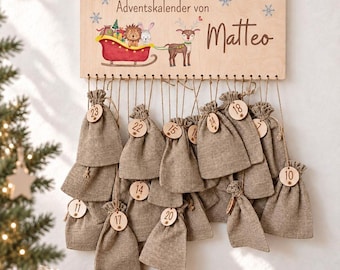 May include: A rectangular wooden sign with the text Adventskalender von Matteo, featuring a printed illustration of a reindeer pulling a red sleigh with a lion and rabbit. Twenty-four small brown burlap drawstring bags hang from the sign.