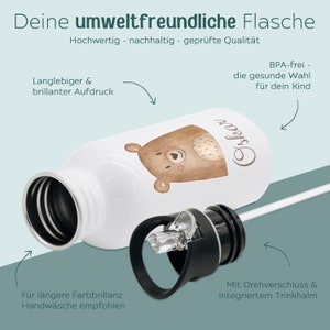 May include: A white water bottle featuring a brown bear illustration and the name Oskar in cursive script. The bottle includes a black screw-top lid with an integrated straw. Text on the image highlights features like BPA-free material and print quality.