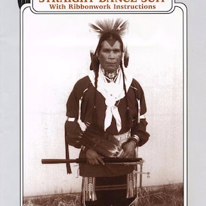 May include: A black and white photo of a man wearing a traditional Native American dance outfit. He is holding a staff and has a white feather headdress. The photo is from a Missouri River Patterns sewing pattern for a Straight Dance Suit with Ribbonwork Instructions.