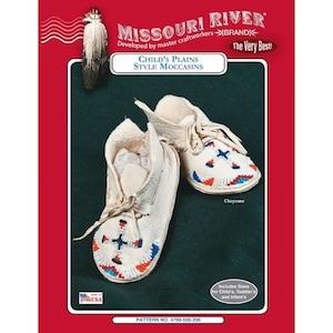 May include: Child's Plains Style Moccasins. These off-white leather moccasins feature intricate beadwork in red, blue, and orange. The design includes a cross and star pattern. The image also includes the text "Missouri River Brand" and "Cheyenne".