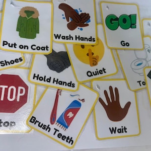 May include: A collection of flashcards with various instructions and illustrations. Cards include "Put on Coat", "Wash Hands", "Go", "Quiet", "Put on Shoes", "Stop", "Hold Hands", "Brush Teeth", "Listen", "Wait", and "Put on Seatbelt". The cards have a yellow border.