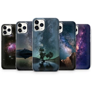 May include: Five different phone cases with a starry night sky design. Each case features a different scene, including a mountain range, a tree, and a nebula.